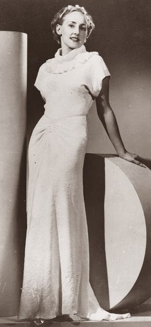 Model posing in a glamorous 1930s evening gown