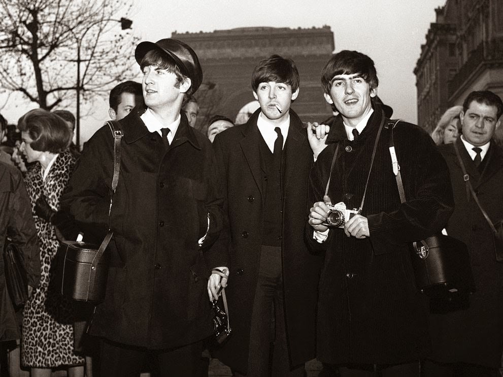 John Lennon, Paul McCartney, and George Harrison sightseeing in Paris, the day before their opening at the Olympia Theatre in Paris, 1964.