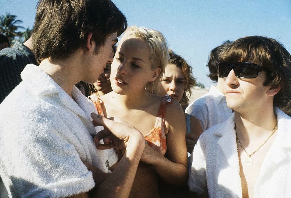 George Harrison and Ringo Starr at the beach in Miami, Florida; others are unidentified, 1964.