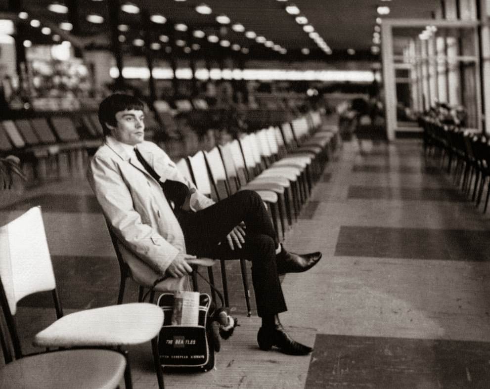 Drummer Jimmy Nicol, who had been stand-in for tonsillitis-stricken Beatle Ringo Starr, sits alone and contemplative at Melbourne's Essendon Airport, while waiting to return home; Ringo rejoined the Beatles the day before, 1964.