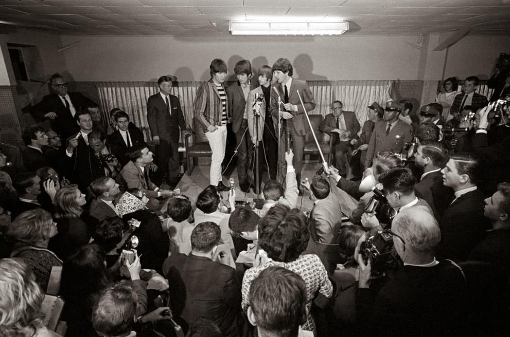 The four members of the Beatles hold a press conference, 1964.