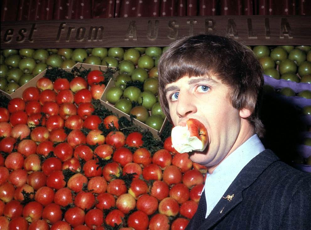Ringo Starr samples an apple during a visit to Australia House in London, 1964.