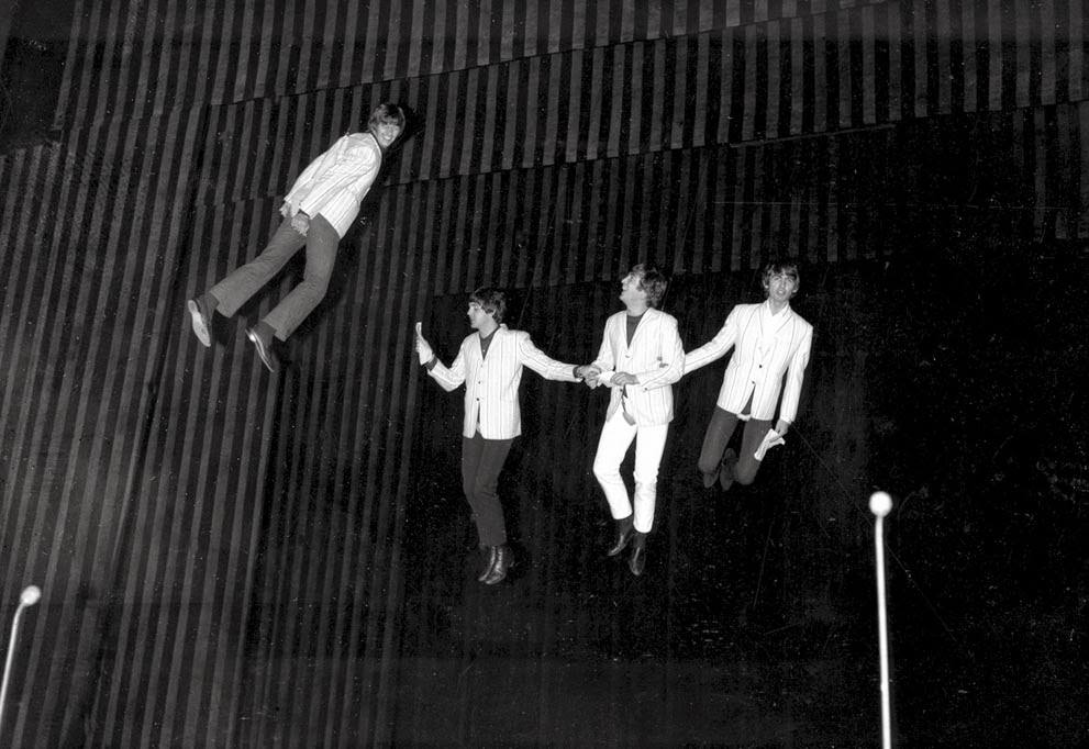The Beatles are suspended in midair above the stage during rehearsal for their part in the charity show "Night of 100 Stars" at the Palladium in London, 1964.
