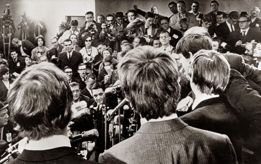 The Beatles face the media on their arrival in New York, 1964.