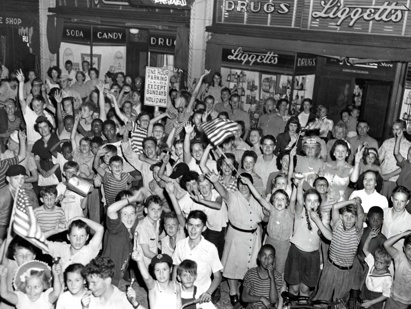 Crowds celebrate the end of World War II in West Newton Square on Washington Street, Boston, 1945.