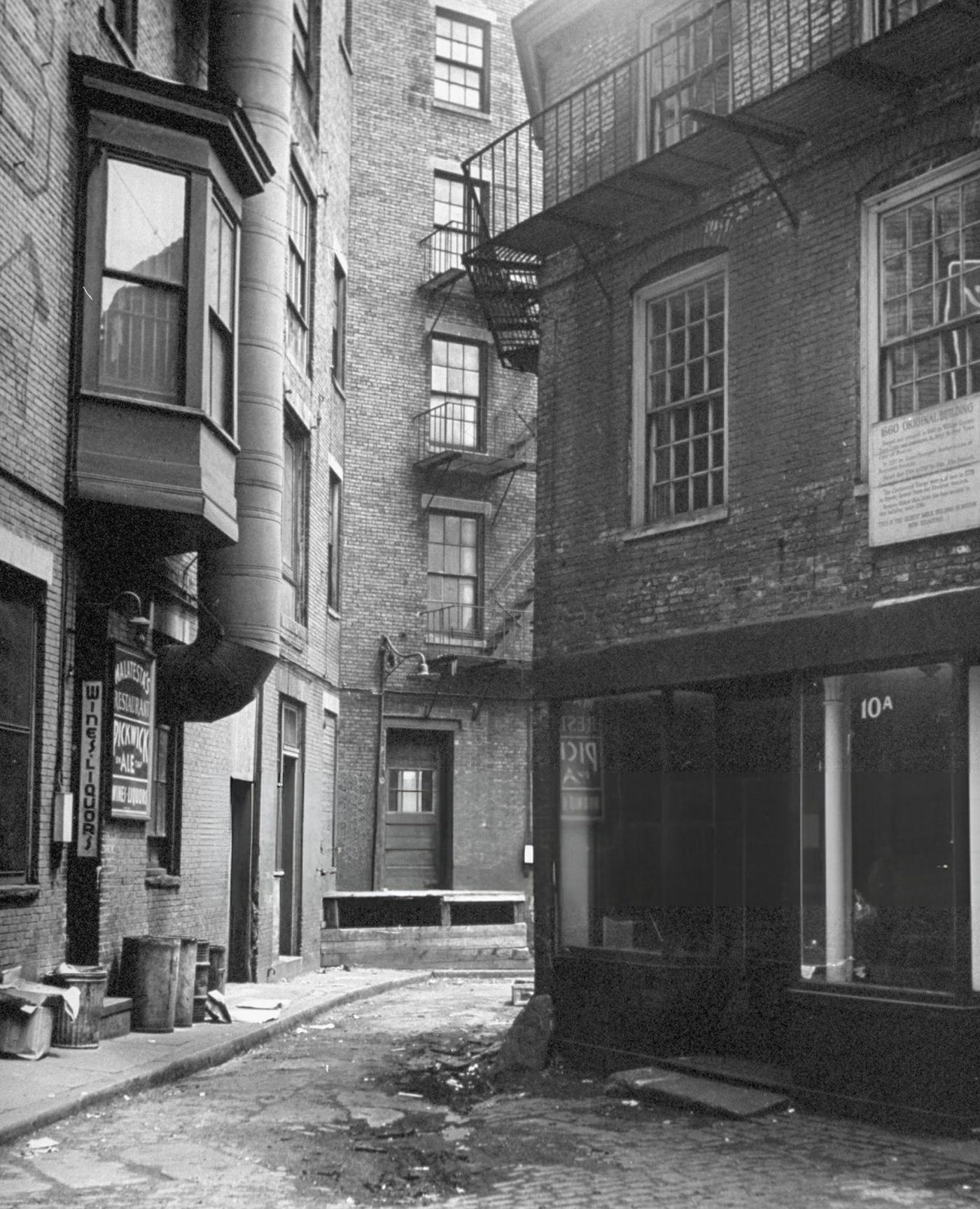 Public 102 Alley, with a sign indicating the city's oldest brick building still standing, just off Dock Square.