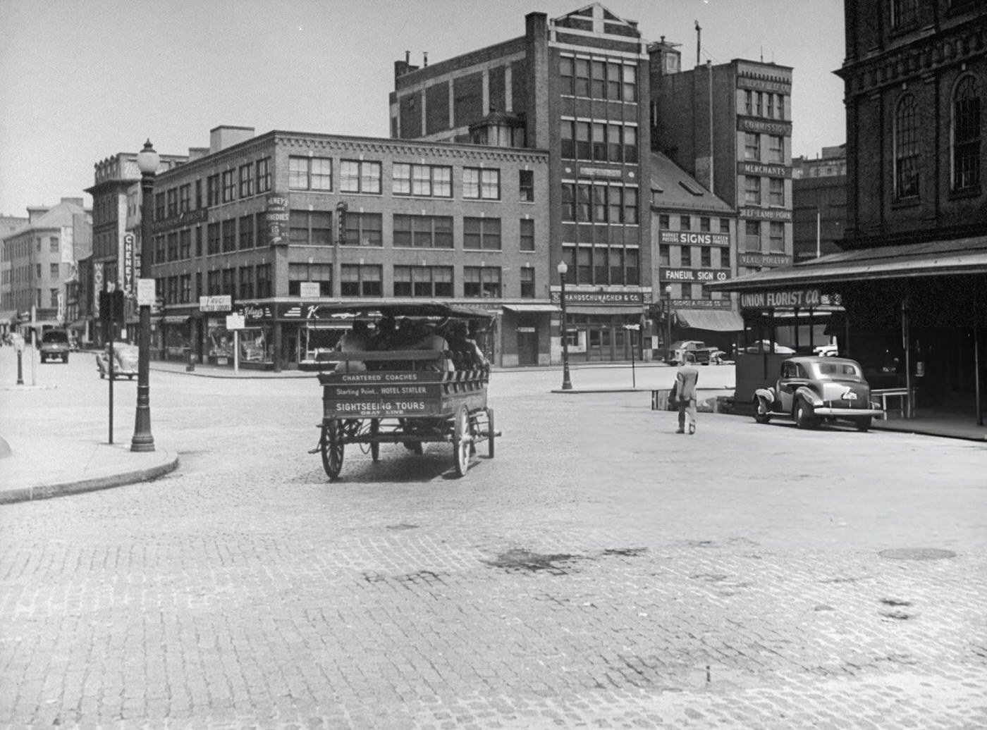 A horse-drawn carriage full of sightseers makes its way through Dock Square.