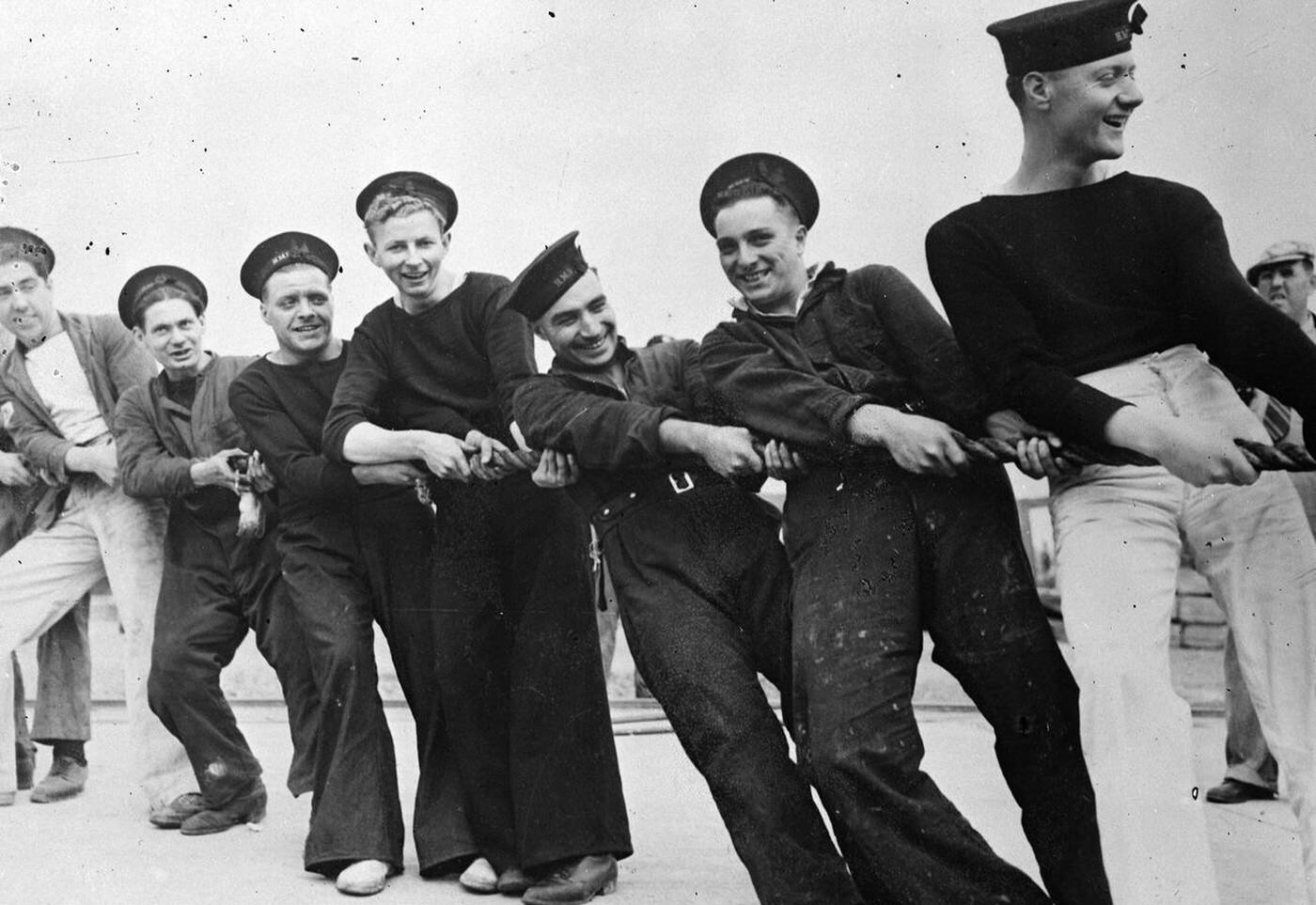 Seaman of the British destroyer Burnham hauling a line as the vessel entered the Boston Navy Yard drydock for repairs, 1941.