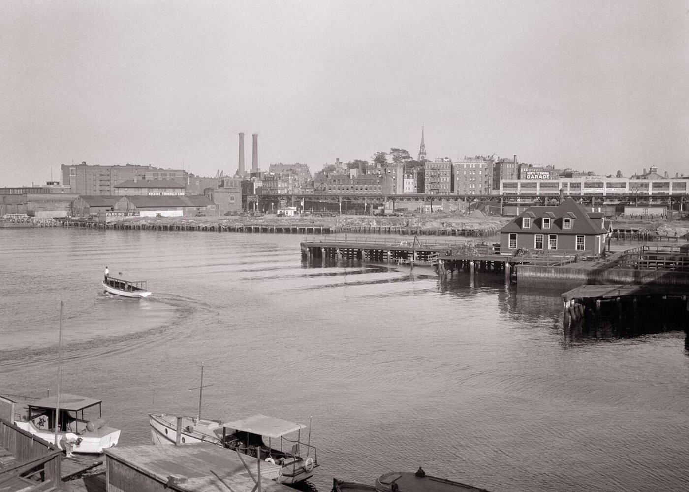 City skyline over the Charles River with the spire of Old North Church visible above newer buildings, Boston, 1940s.
