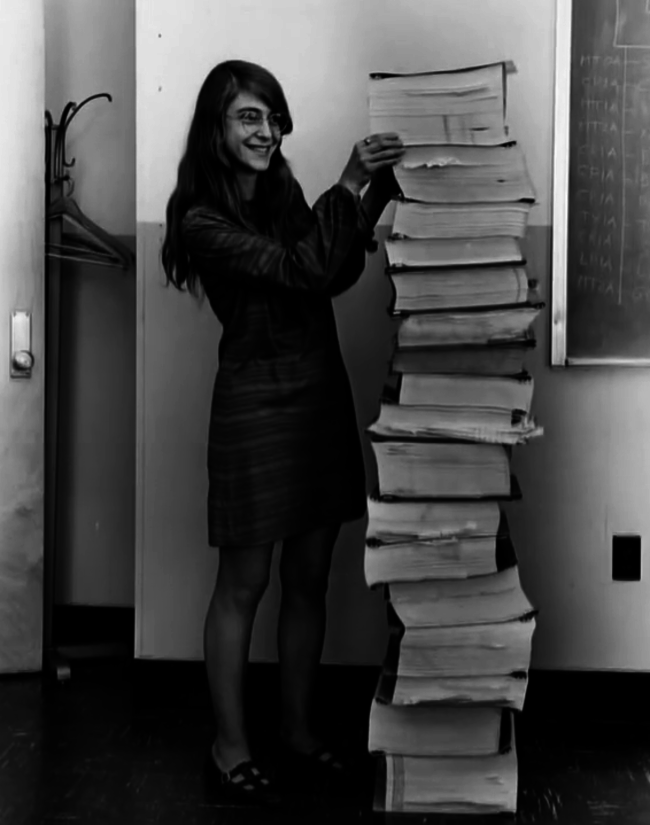 Margaret Hamilton, lead software engineer of the Apollo Project, stands next to the code she wrote by hand and that was used to take humanity to the moon, 1969.