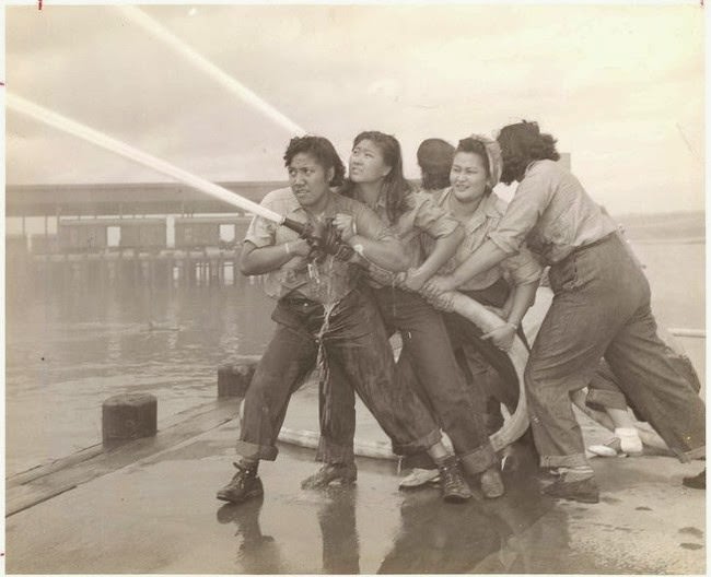 Volunteers learn how to fight fires at Pearl Harbor, 1940s.