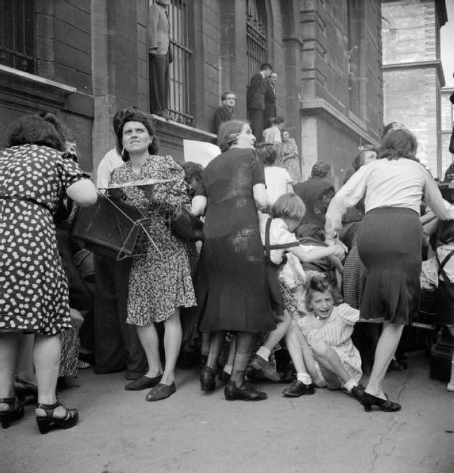 Parisian mothers shield their children from German sniper fire, 1944.