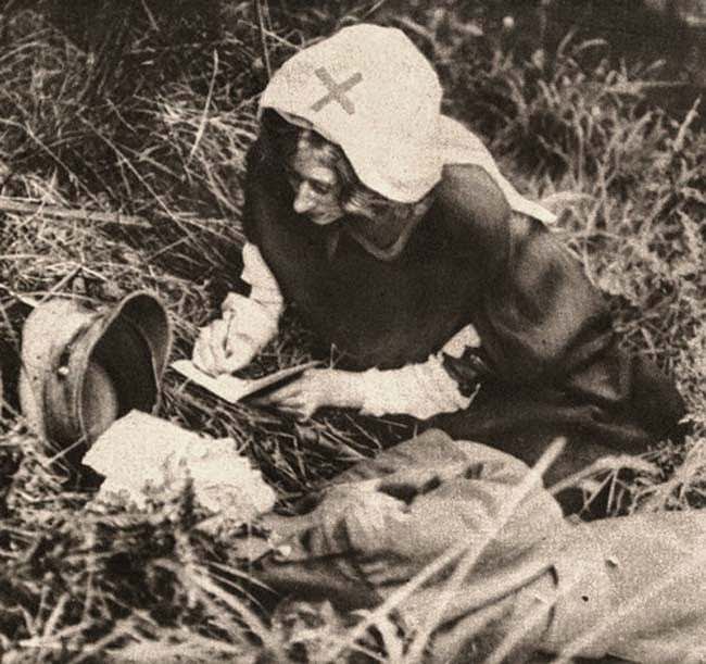 A Red Cross nurse takes down the last words of a British soldier, 1917.