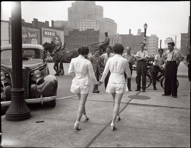 Two women show uncovered legs in public for the first time in Toronto, 1937.