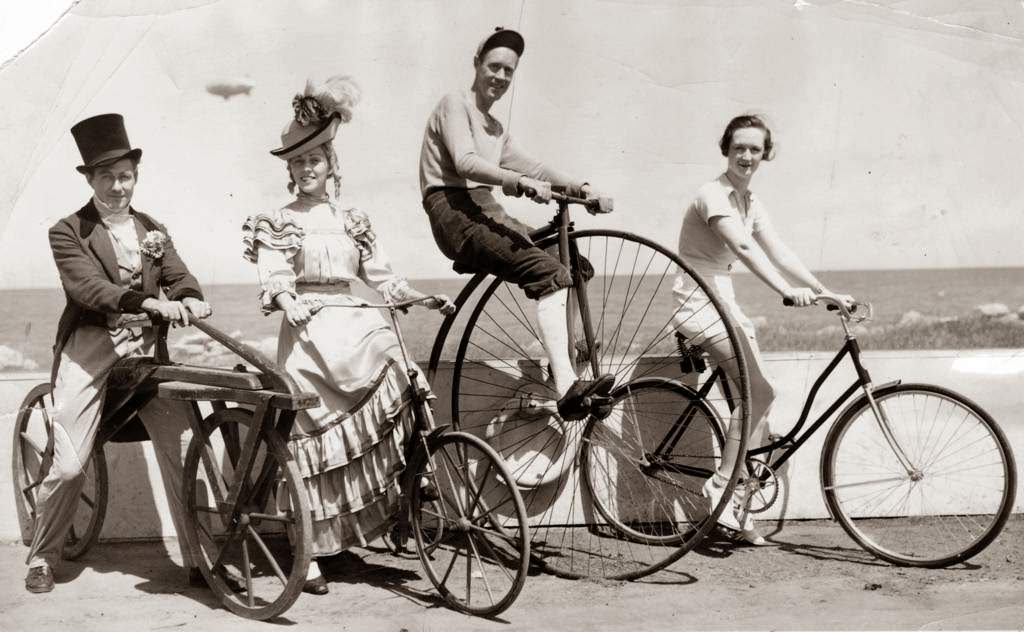 These wheels and many others took part in a huge parade of more than 6,000 cyclists celebrating Bicycle Day at the Chicago World's Fair; pictured left to right are Robert Van Deventer, Helen Trudel, Allen Blair from the cast of Wings of A Century, and Louise Lindsay from the Cycle Trades of America exhibit, 1934.