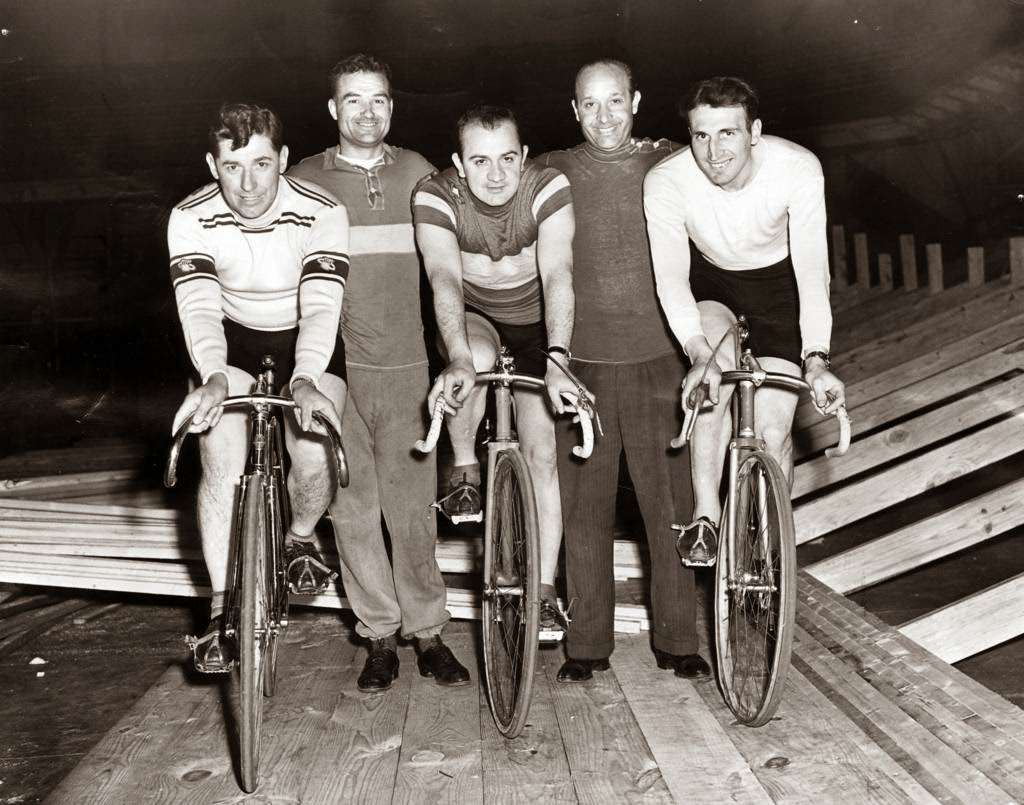 Cocky O'Brien, Charley Logan, Val Melchiori, Tom Saetta, and Cesare Moretti eager to start Chicago's first post-war six-day bike marathon of the year at the Coliseum in Chicago, 1946.