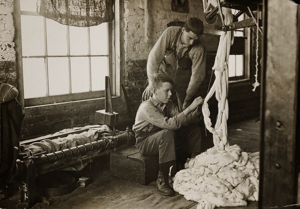 Boy at warping machine. Been there 2 years. Clyde Cotton Mill. Newton, North Carolina, USA 1908.