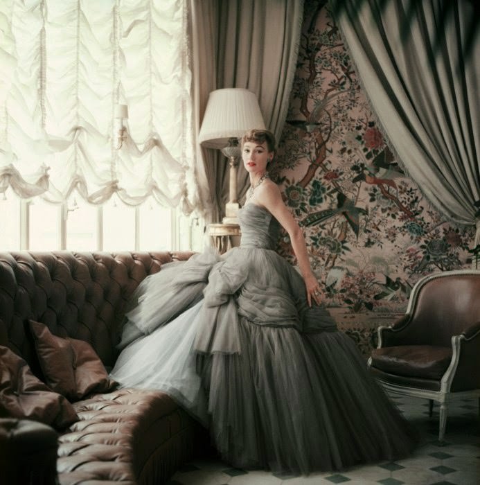 Sophie Malgat, wife of film director Anatole Litvak, models an evening dress from the Autumn-Winter 1953 haute-couture collection in the Jardin d’Hiver of Christian Dior’s hôtel particulier.