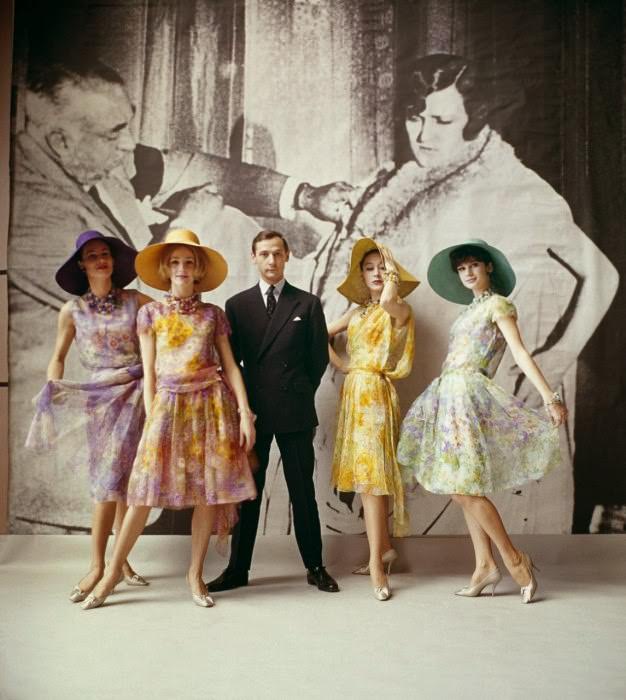 Dior creative director Marc Bohan with models from his first collection, which included the Jardin d’Italie, Jardin de Paris, Jardin d’Espagne, and Jardin Anglais dresses, Spring-Summer 1961 haute-couture collection.