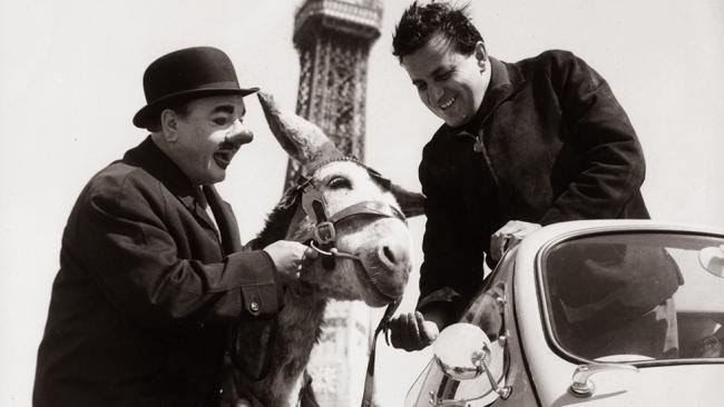 Clown Charlie Cairoli from the Blackpool Tower circus and his donkey wishes Andre Baldet good luck for his 48 hour drive to Paris and back in a Trojan Lambretta bubble car.