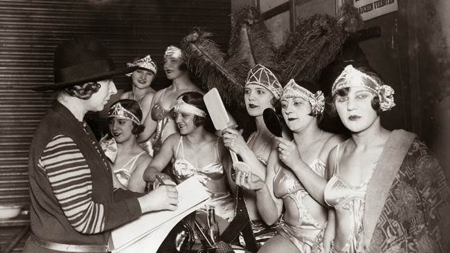 Artist Dame Laura Knight sketching chorus girls behind the scenes at a circus at Olympia.