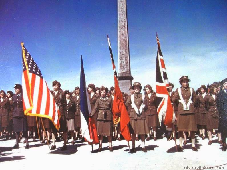 ETO WACS celebrate 3rd anniversary in Paris. View of ETO WACS assembled in review in front of the Place de la Concord in Paris, France. In a history making parade down the famous Champa Xlysses Ave., ETO WACS marched in the first all women parades in the history of the city. Guests in the parade were detachments of English ATS, WAAPS and French WACS. They were led by the US Army Band and a WAC color guard.