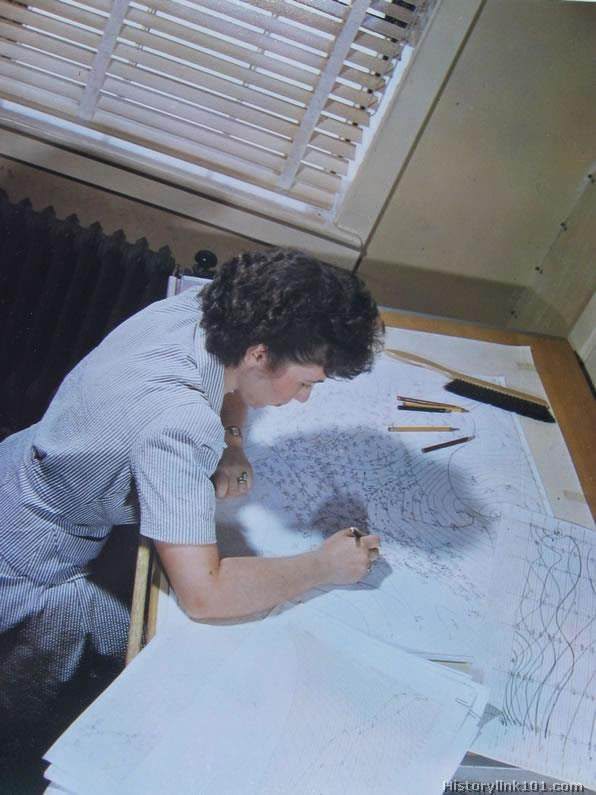 A WAAC in training at a WAAC Training Center. She looks over the paper records in the control tower at an airport.
