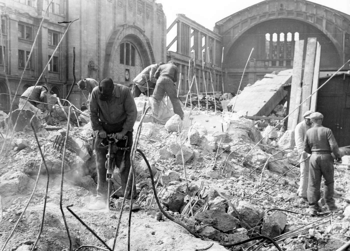 People remove debris at the main train station in Leipzig, 1945.
