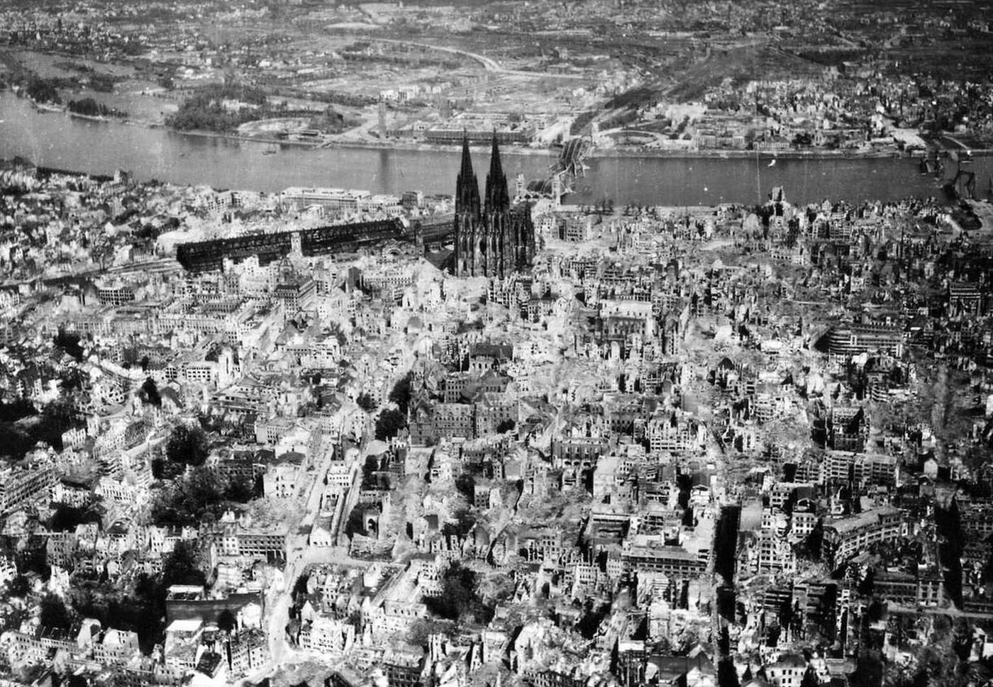 Cologne Cathedral stands tall amidst the ruins of the city after allied bombings, 1944.