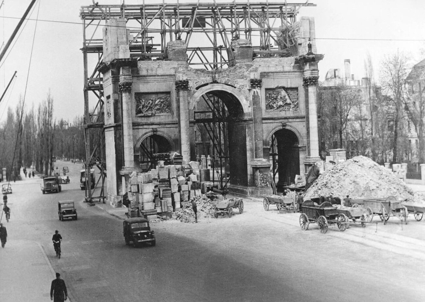 Reconstruction of the Munich Siegestor that was destroyed by air raids, 1945.