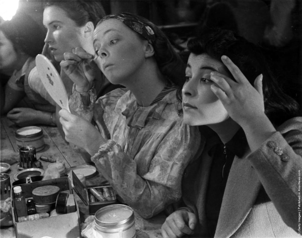 Students at the Royal Academy of Dramatic Art in Bloomsbury, London, applying make-up backstage, 1938.