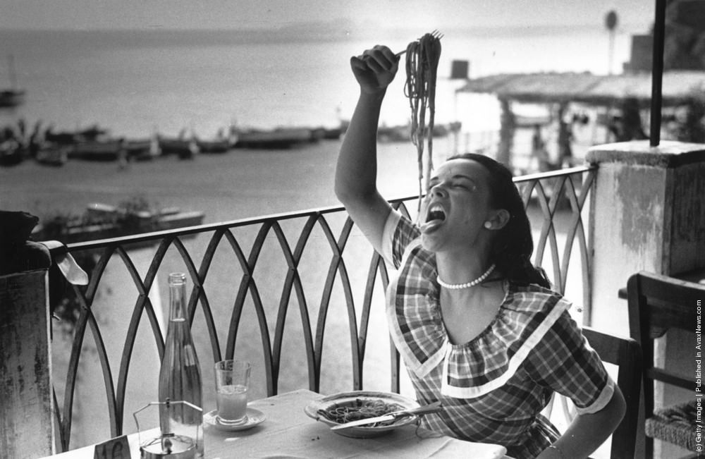 London student Mercy Haystead enjoys a plate of spaghetti while on holiday in Italy as an official guest of the town of Positano, 1949.