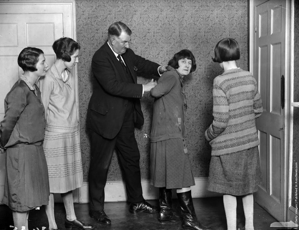 Lady detectives learning their trade, with Mr. Kersey showing them how to apprehend a suspect, 1927.