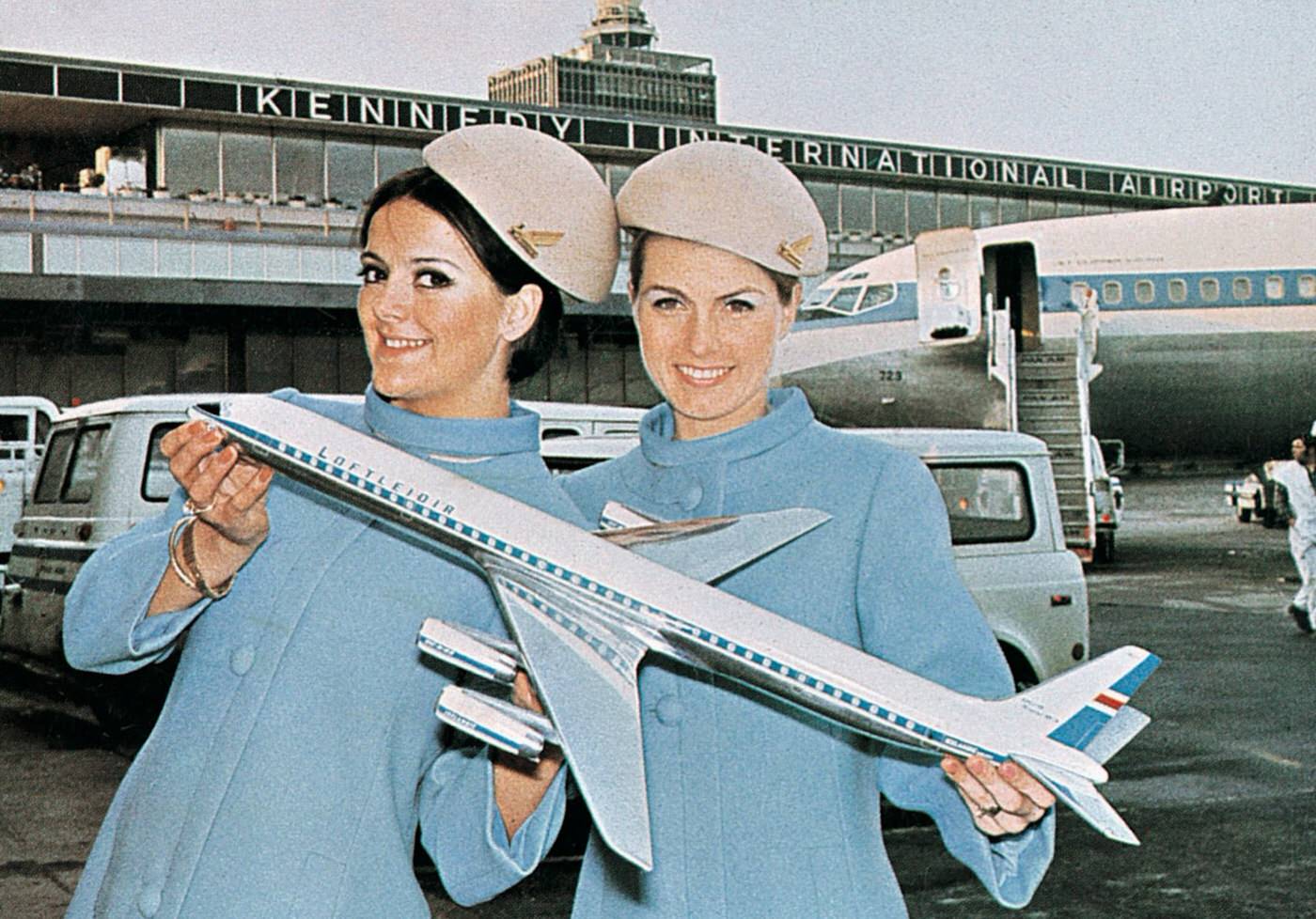 Icelandic Air stewardesses pose with a model Douglas DC-8, 1960s.