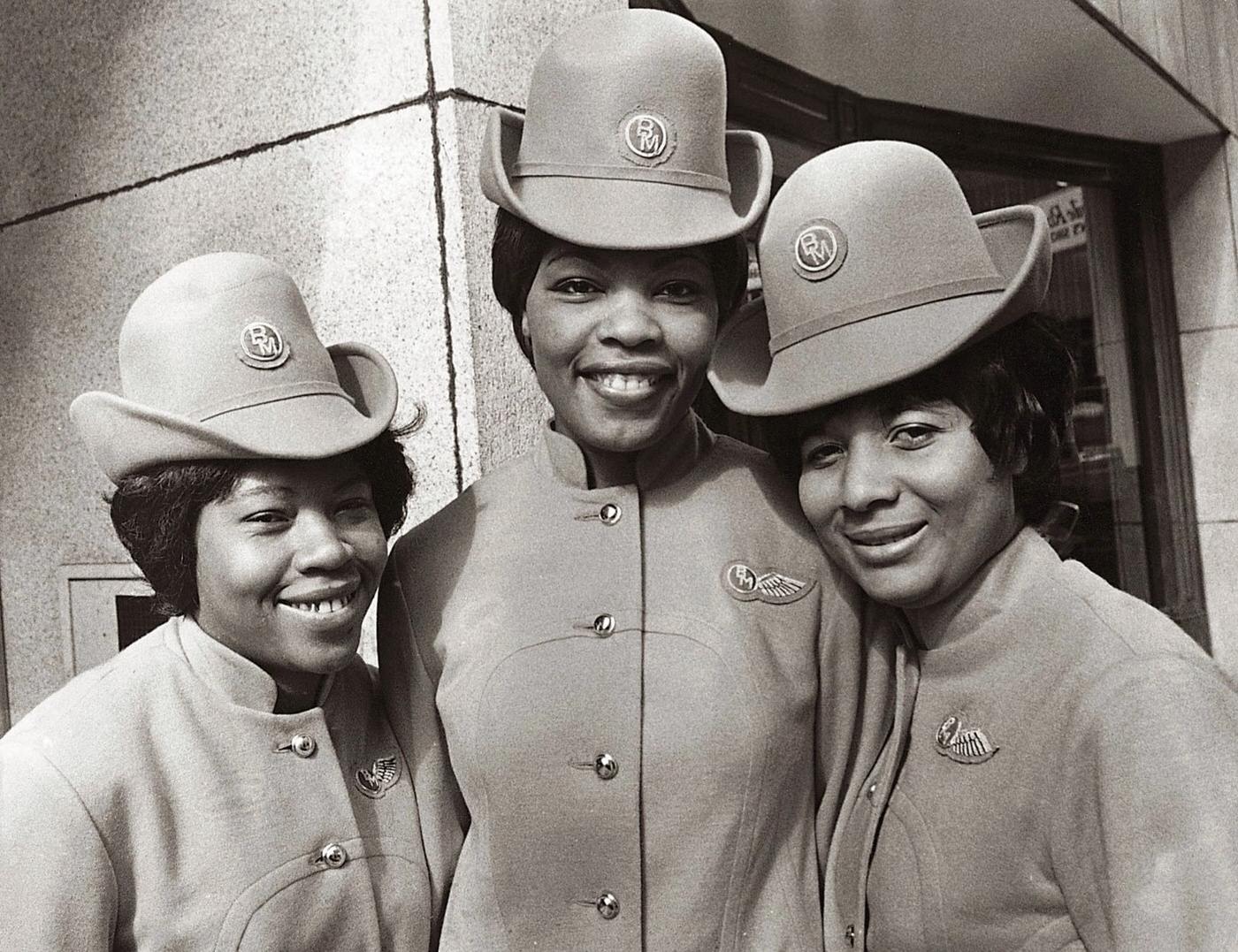 The first UK-based non-white stewardesses to be employed by an independent airline received their 'wings' at the London offices of British Midland Airways in 1970. From left: Innez Matthews, Irma Reid and Cindy Medford.