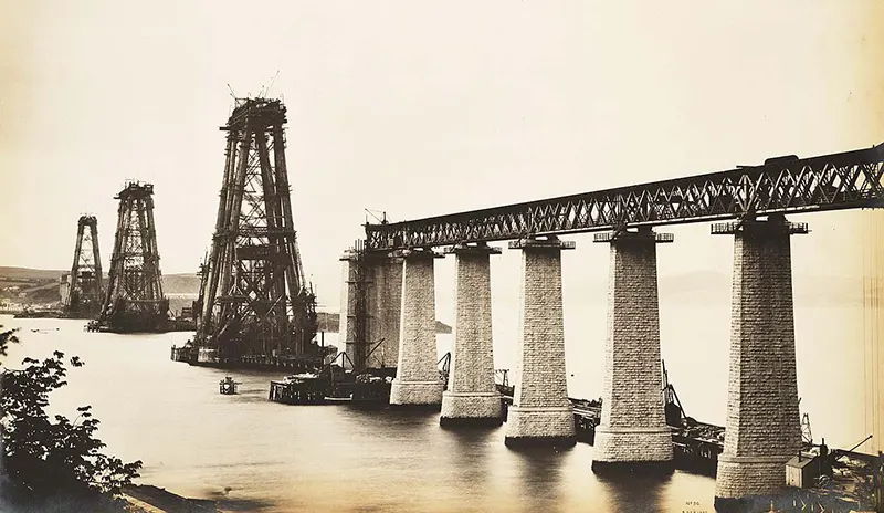 A view from South Queensferry of the bridge’s cantilever towers being built, 1887.