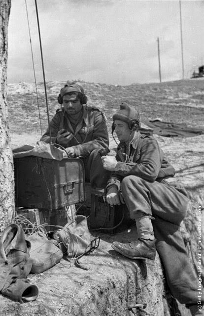 A pair of Greek soldiers make contact with their troops on a field radio during the Greek Civil War, 1948.