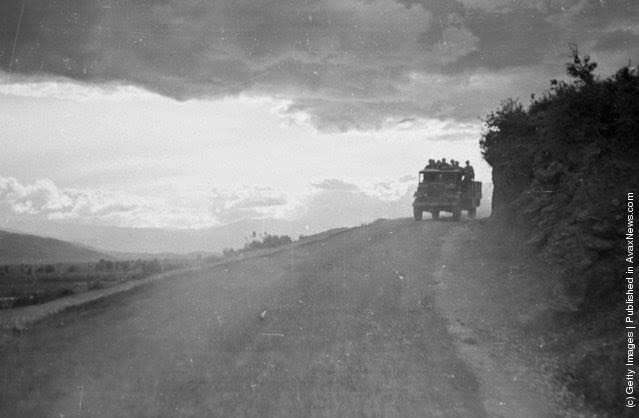 Government troops are instructed to cease travelling and fortify their position during the night, when the guerrilla army is more likely to attack; the last transport of the night makes its way along a lonely mountain road during the Greek Civil War, 1948.