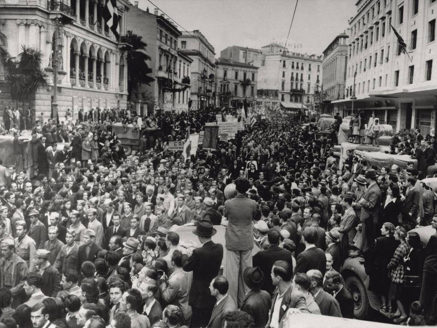 Partisan formations marching in a crowded street of Athens to celebrate the liberation on the fourth anniversary of the Axis forces attack, Athens, Greece, 1944.