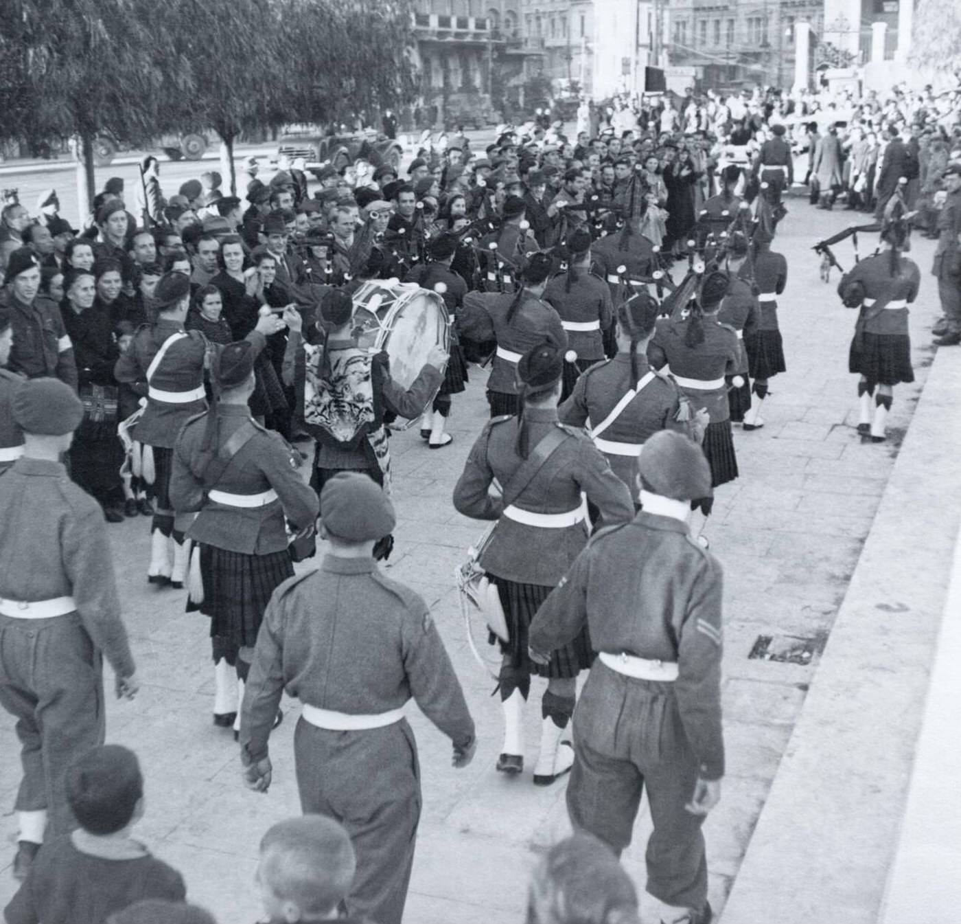 British soldiers of the Parachute Regiment alongside a Scottish band in Athens, 1945.