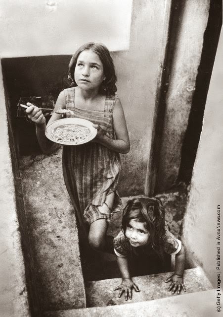 Refugee children in a filthy cellar at Piraeus during the Greek Civil War, 1947.