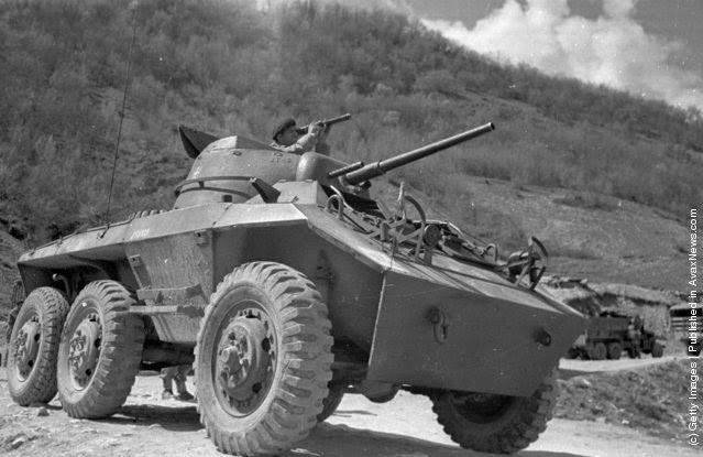 A Greek soldier surveys the surrounding mountainside from his tank during the Greek Civil War, 1948.