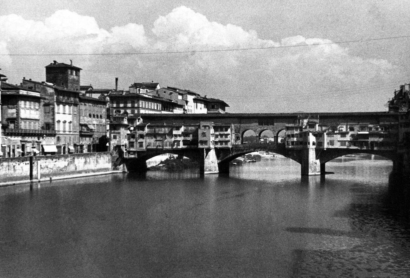 Bridge and river in Florence Italy, 1930s.