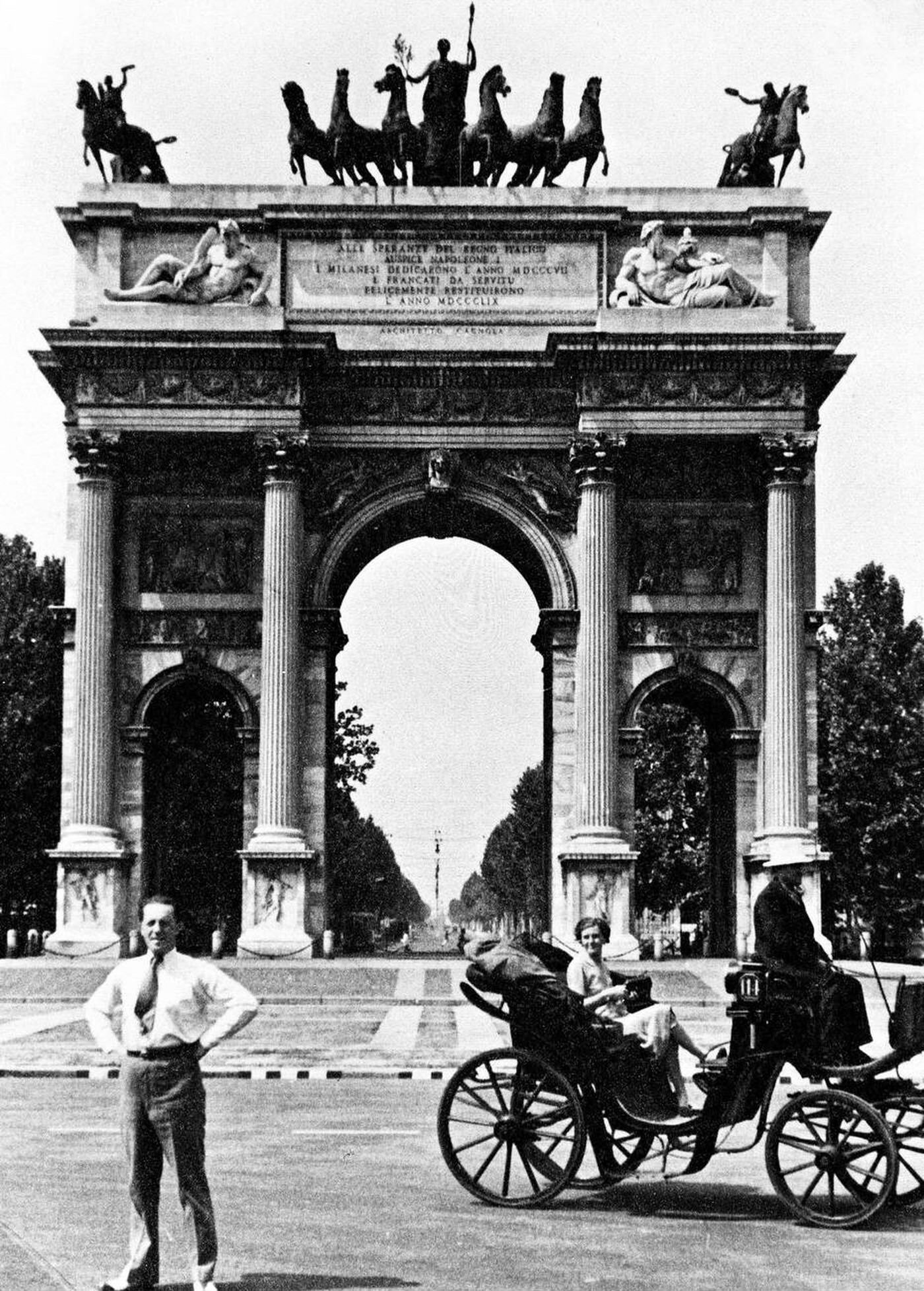 Tourist standing in front of the Arco della Pace in Milan Italy, 1930s.