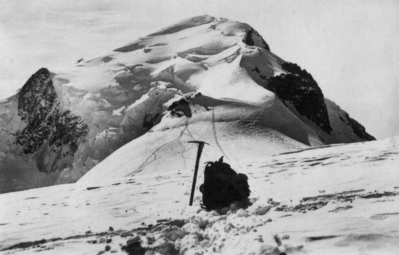 The mountain Mont Blanc with an ice axe and knapsack in the foreground, 1930s.