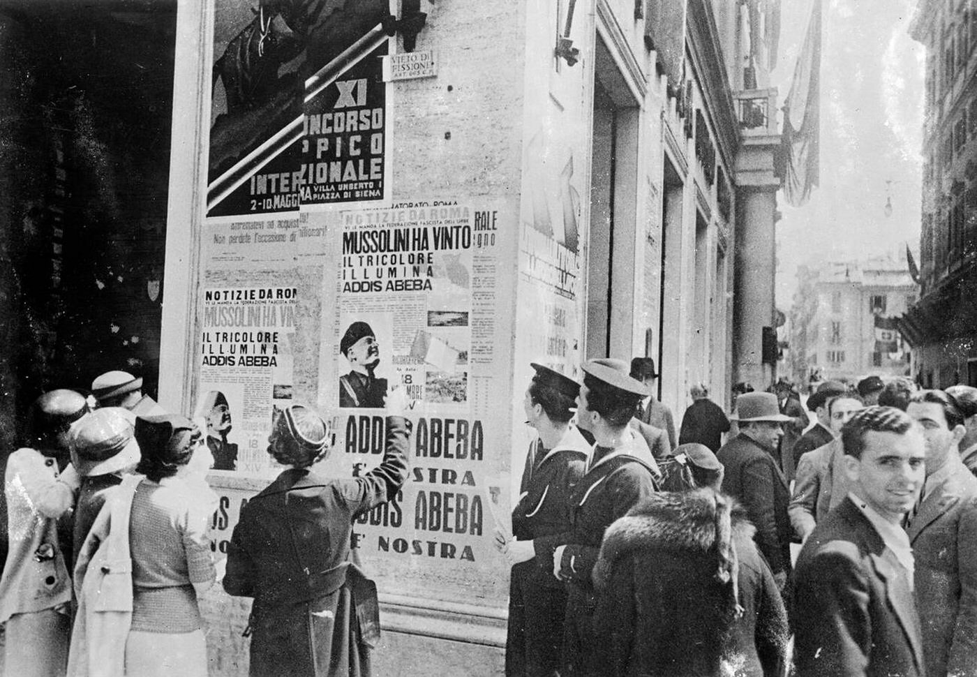 Reading posters announcing the conquest in Rome, 1936.