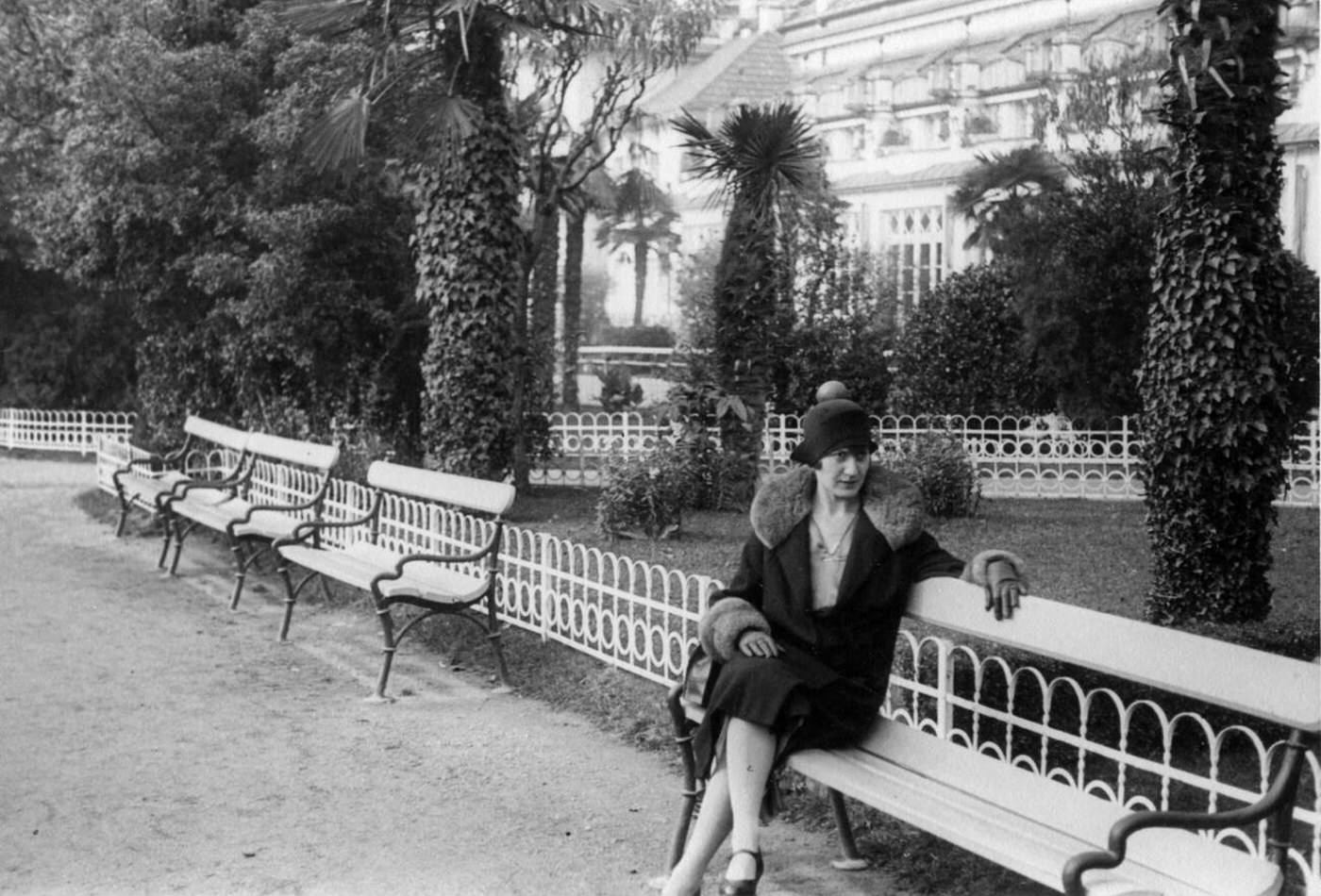 Woman sitting on bench, Merano, Italy, 1930.
