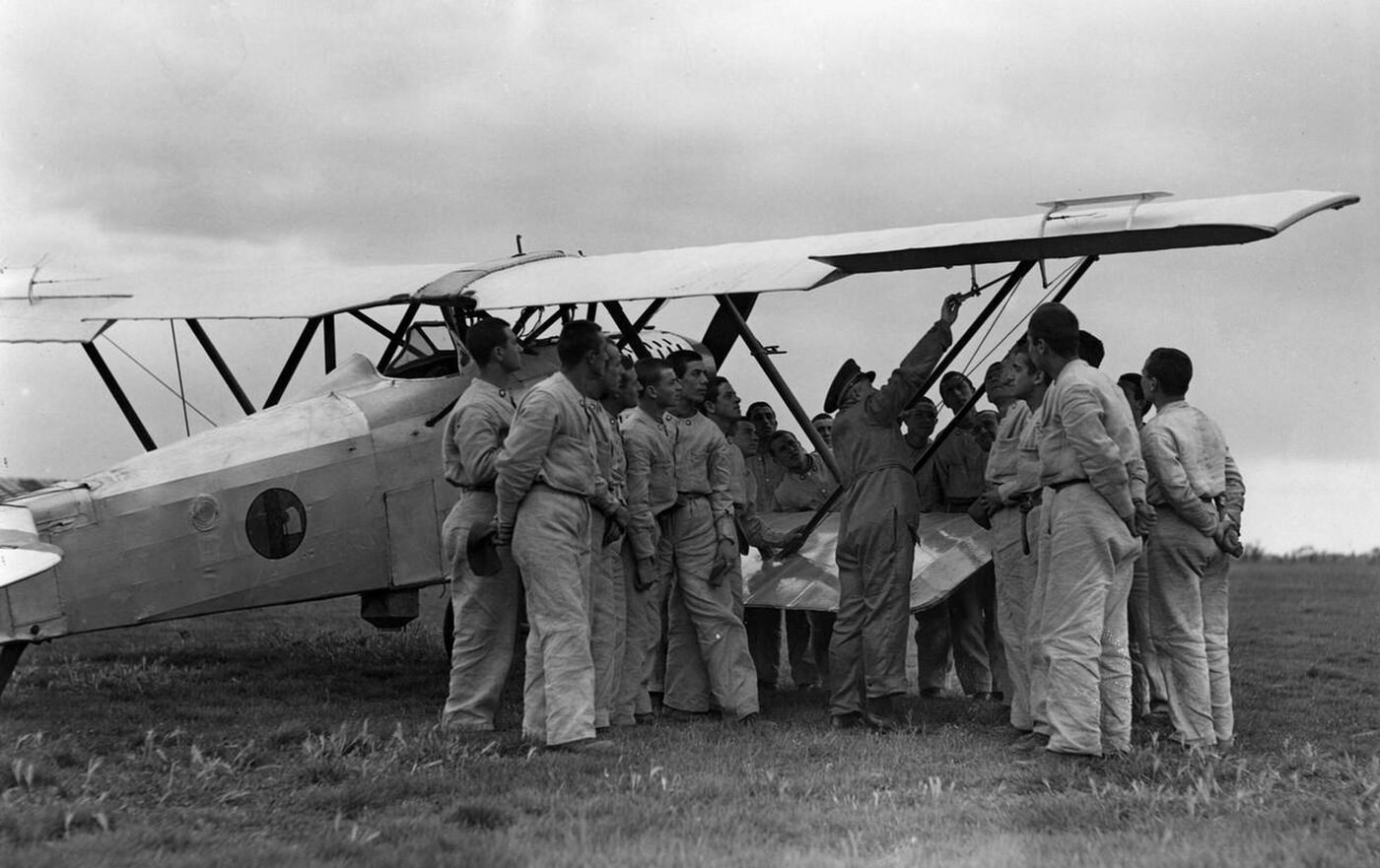 Instruction of aircraft mechanics with a biplane, aviation school of the Regia Aeronautica, Italy, 1930s.