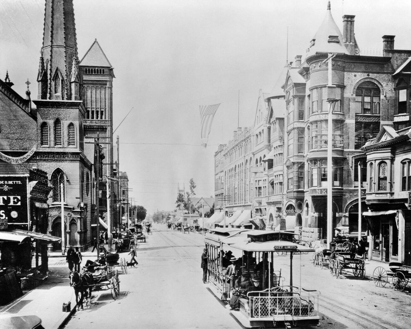 Cable car downtown on Broadway looking south from 2nd Street, with pedestrians, horses and wagons, Los Angeles California, 1880s.