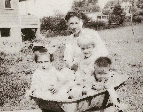 Freda Castle posed with her children, Ruth, Walter and John, in a concrete mixing trough in Long Hill Township, 1928.